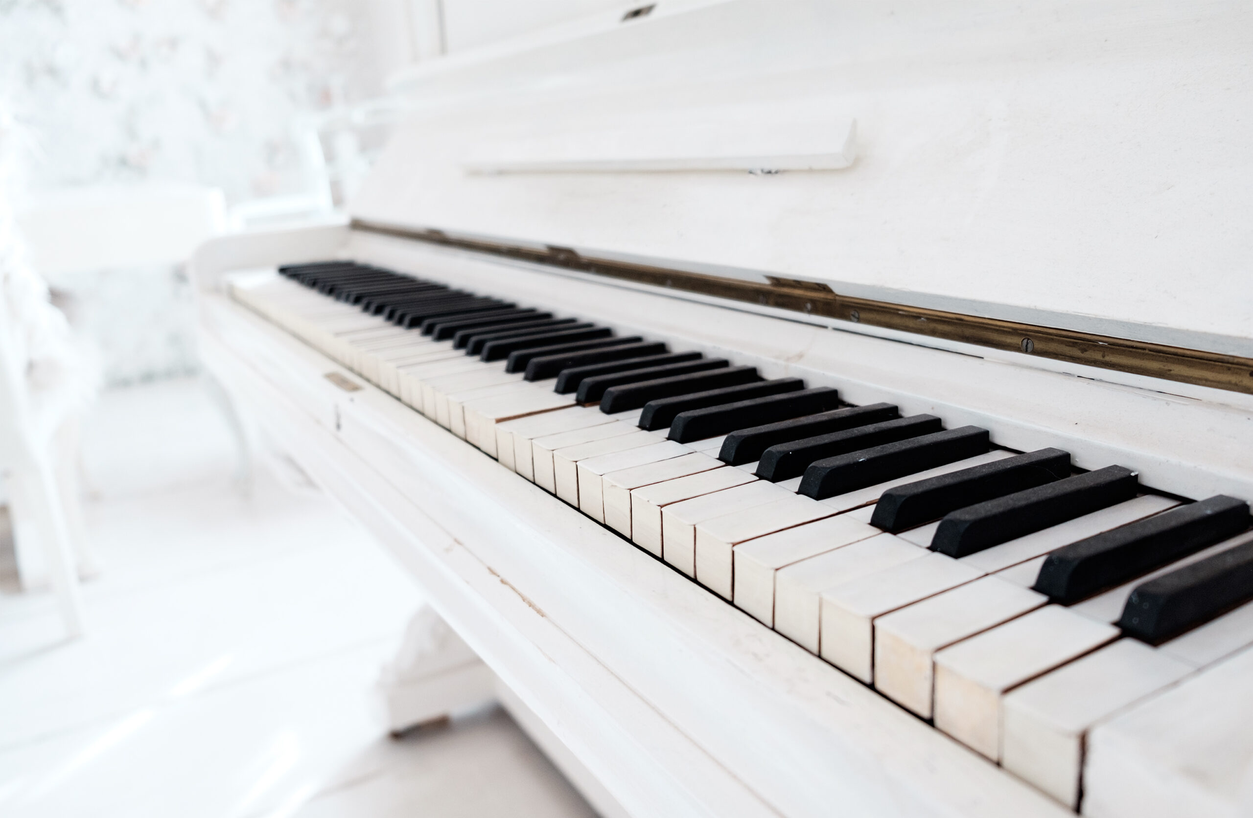 White vintage piano in a white room